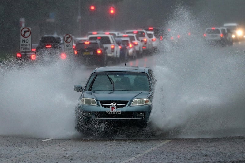 A car drives through a pool of water on the Northern Beaches in Sydney. EPA