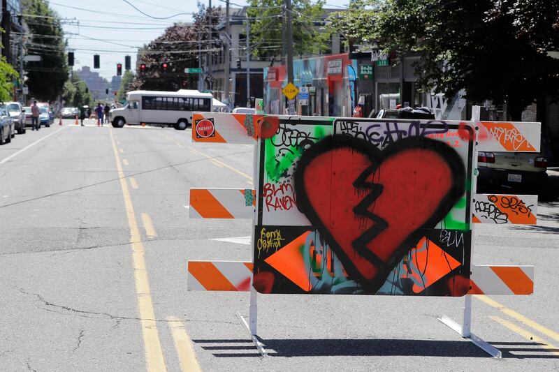 A broken hear is painted on a street barricade near one of the entrances to what has been named the Capitol Hill Occupied Protest zone in Seattle. AP Photo