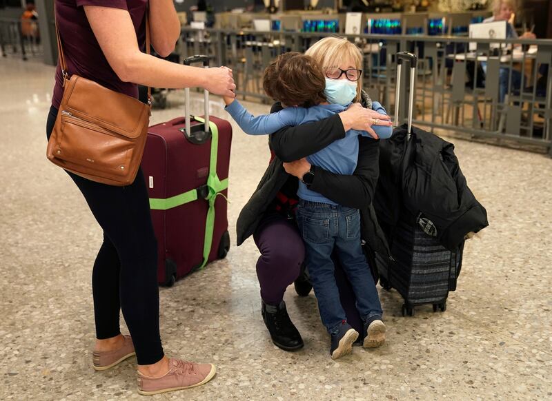 A woman hugs her grandson that she has not seen in three years upon her arrival from Frankfurt, Germany, at Dulles International Airport. Reuters