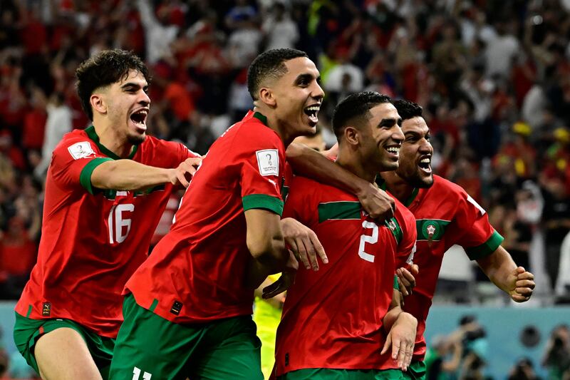 Morocco's Achraf Hakimi celebrates with teammates after scoring the winning penalty. AFP