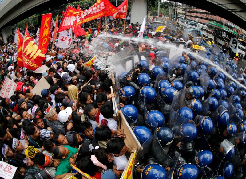 Filipino activists clash with riot police during a protest rally in Manila.  Francis R Malasig / EPA