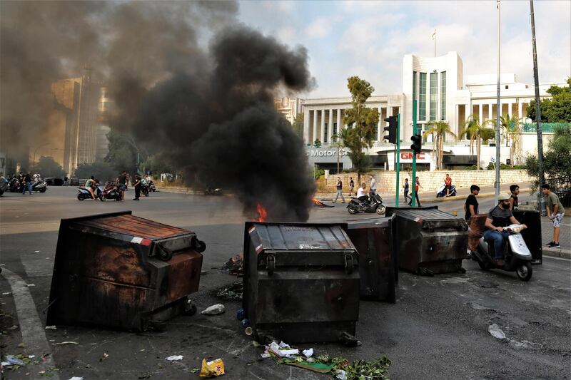 Anti-Government protestors set garbage bins on fire and block the majority of the main roads. EPA