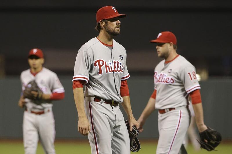 Pitcher Cole Hamels, center, is having a strong year on a woeful team so he could be traded to a title contender very soon. Jeff Chiu / AP Photo

