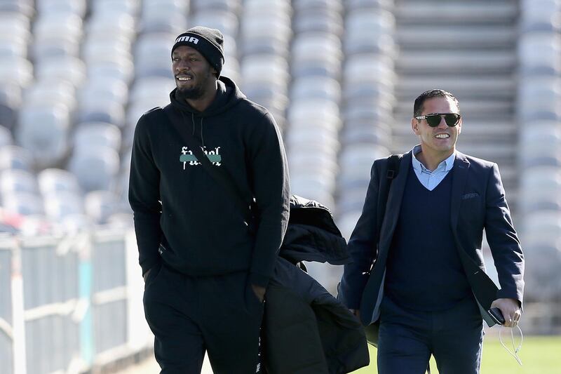 Usain Bolt arrives with manager Ricky Sims for his first training session. Getty Images