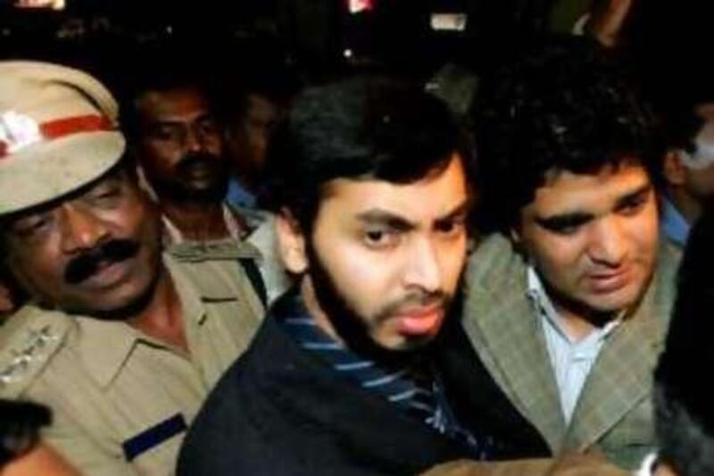 Indian doctor Mohamed Haneef (C) comes out of the Bangalore International Airport after his arrival in Bangalore, 29 July 2007.  Haneef returned to the city after Australia's chief prosecutor dropped terrorism charges against the 27-year-old doctor. AFP PHOTO/Dibyangshu SARKAR