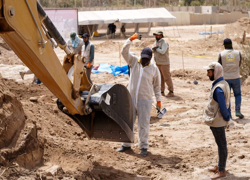 A backhoe being used to uncover the site of a mass grave in Najaf, discovered by chance when property developers began to prepare the land for construction.