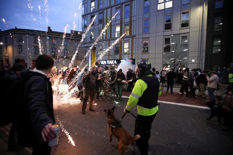 Fireworks are launched as protesters clash with police officers in Bristol. Reuters