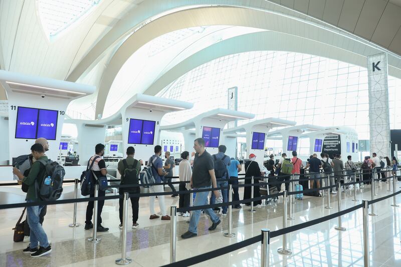 Passengers queue at the check-in desks in Terminal A. The first commercial flight went to New Delhi 