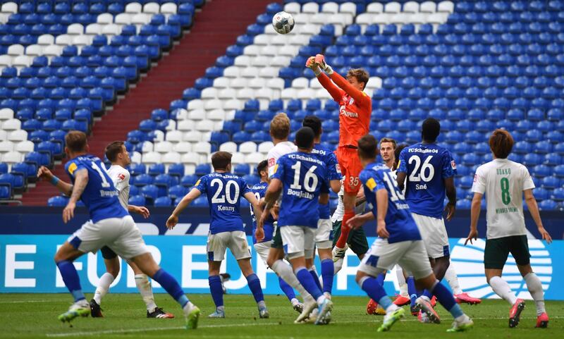 Schalke goalkeeper Alexander Nubel punches the ball clear. Getty