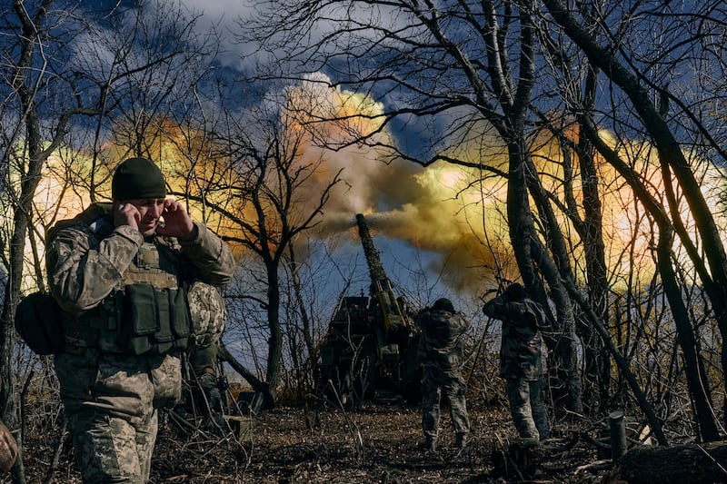 Ukrainian soldiers fire a howitzer towards Russian positions, near Bakhmut in Ukraine. AP