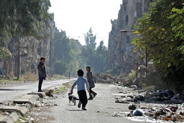 Play time in the rubble-strewn streets of Yarmouk, where many Palestinians live, on the edge of the Syrian capital Damascus. A rising number of children in the country are going hungry. AFP