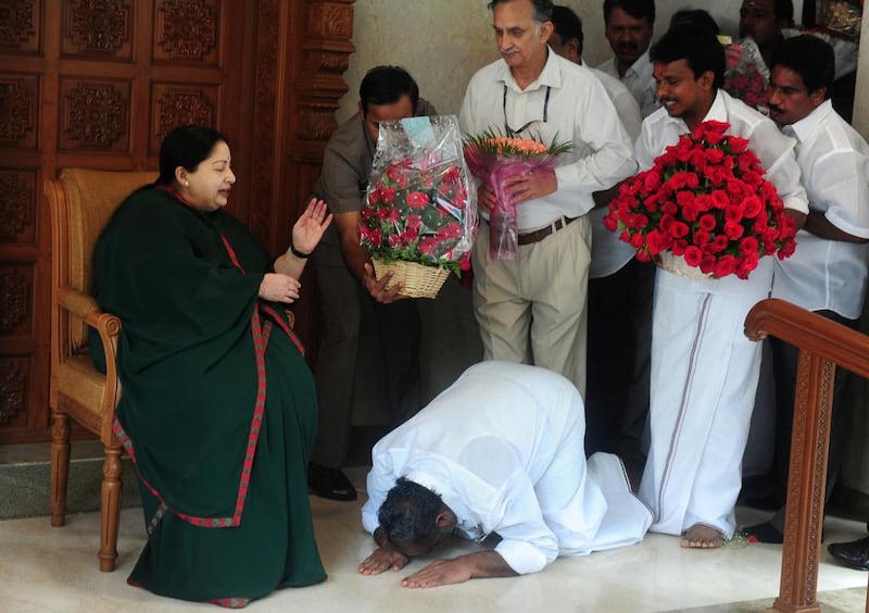 A party cadre prostrates himself at the feet of former chief minister of Tamil Nadu, J Jayalalithaa at her residence in Chennai on May 19, 2016. Arun Sankar/AFP Photo