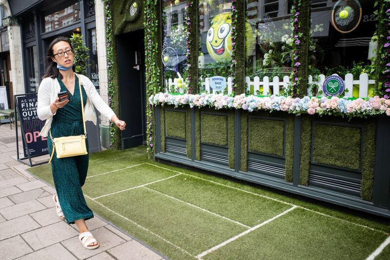 In the run up to the Wimbledon tennis championship reporter Tim Stickings and I visited and interviewed locals to guage the feeling ahead of the competition. Many local businesses create elaborate window displays to celebrate the tennis, one of the best we saw was at the Thai Tho restaurant complete with signed tennis ball shrine watched over by a Buddha statue.