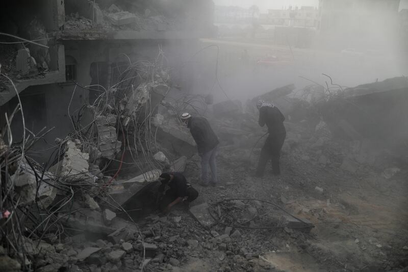 Palestinians search for bodies and survivors among the rubble of a destroyed house following an Israeli air strike on Deir Al Balah. EPA