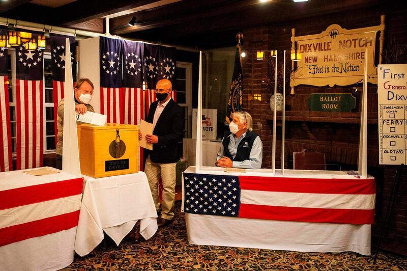 Tom Tillotson drops voters ballots into the ballot box at the Hale House at the historic Balsams Resort during midnight voting as part of the first ballots cast in the United States Presidential Election in Dixville Notch, New Hampshire. AFP