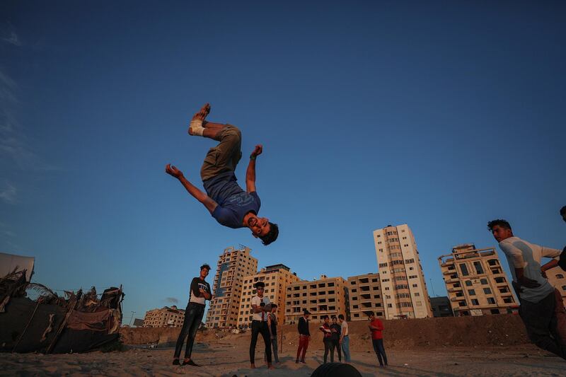 Palestinian youths from Gaza's Free Parkour team practice their skills next to the beach in Gaza City.  EPA