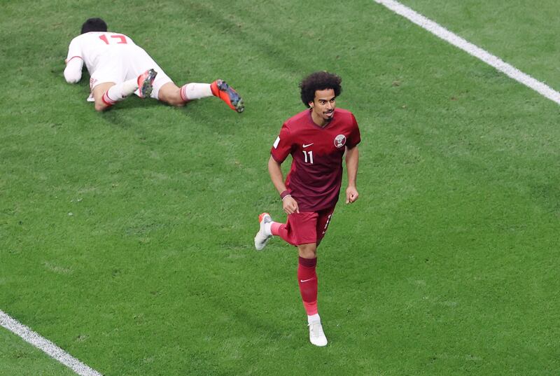 Qatar's Akram Afif celebrates after United Arab Emirates' Ali Salmeen scored an own goal, the first in the home side's 5-0 win. Reuters