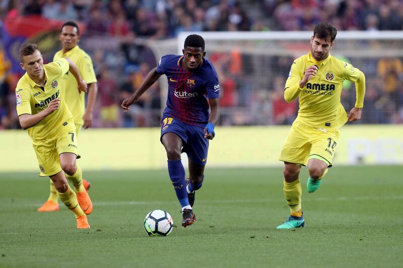 epa06723665 Barcelona's winger Ousmane Dembele (C) and Villarreal's midfielder Manu Trigueros (R) and winger Dennis Cheryshev in action during the Spanish Primera Division soccer match between FC Barcelona and Villarreal CF at Camp Nou stadium in Barcelona, Catalonia, Spain, 09 May 2018.  EPA/TONI ALBIR