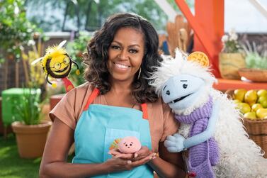 Former first lady Michelle Obama with puppets Busy, left, Mochi, centre, and Waffles, right, on the set of children's series 'Waffles + Mochi'. AP