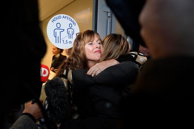 Relatives of the MH17 victims embrace after the trial. AFP