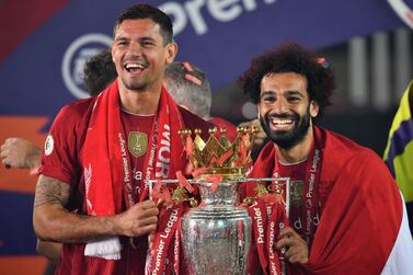 Liverpool's Mohamed Salah wears an Egyptian flag around his shoulders as he and teammate Dejan Lovren lift the Premier League Trophy at Anfield. PA