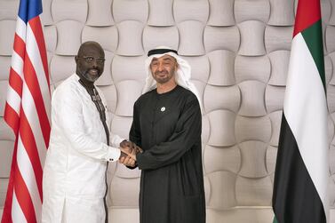 Sheikh Mohamed bin Zayed, Crown Prince of Abu Dhabi and Deputy Supreme Commander of the UAE Armed Forces, right, greets George Weah, President of Liberia  after a dinner meeting at Zuma restaurant. Ryan Carter / Ministry of Presidential Affairs 
