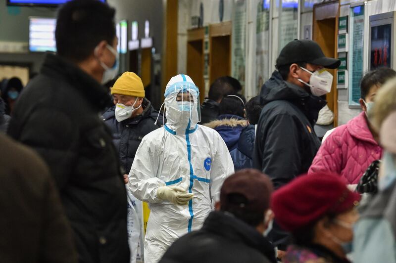 A medical staff member (C) wearing protective clothing to help stop the spread of a deadly virus which began in the city, walks at the Wuhan Red Cross Hospital in Wuhan. AFP