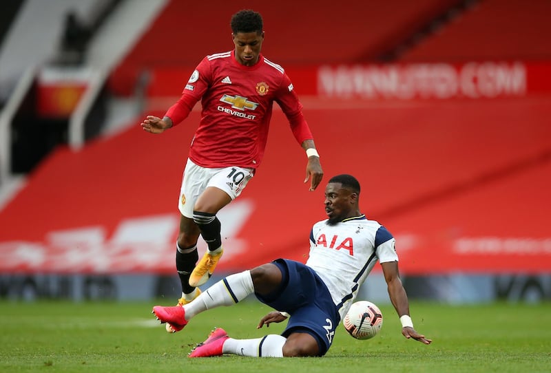 United's Marcus Rashford is tackled by Serge Aurier of Spurs. PA