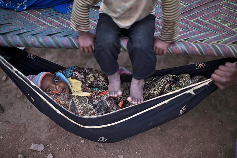 A Pakistani child, lies in a hammock at the site of his mother's work in a brick factory in Mandra, near Rawalpindi, Pakistan. Muhammed Muheisen AP Photo