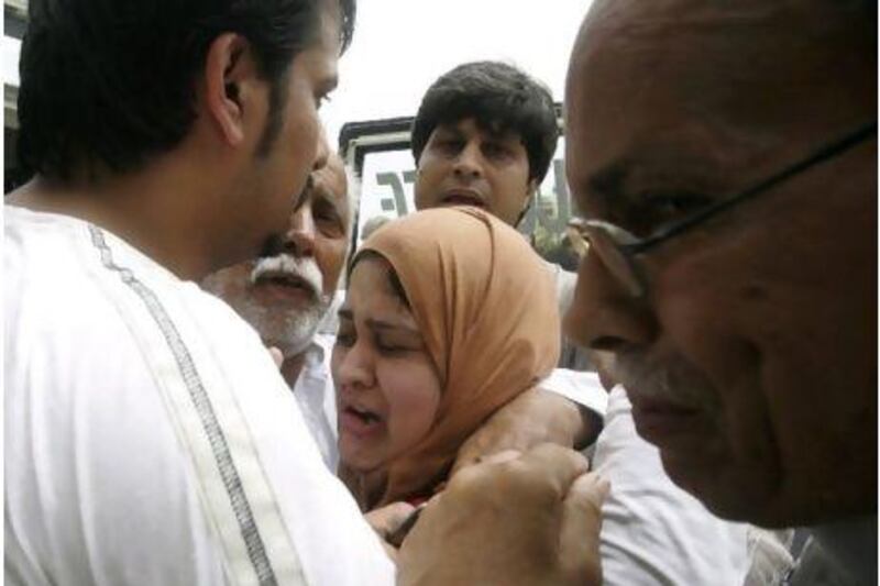Family members of the murdered Pakistani journalist Syed Saleem Shahzad react after his death, in Karachi yesterday. Fareed Khan / AP Photo
