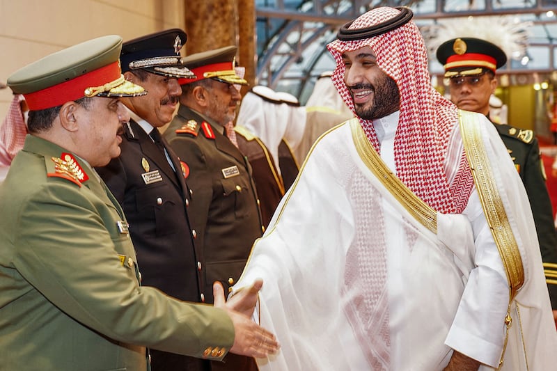 Saudi Crown Prince Mohammed bin Salman shakes hands with a high-ranking military officer during his reception in Kuwait City. AFP