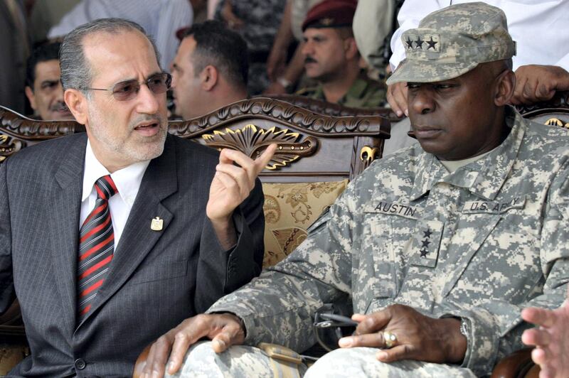 Iraq's National Security Adviser Muwaffaq al-Rubaie (L) gestures next to US army Lt General Lloyd Austin, commander of US-led forces in Diwaniyah province, during a handover ceremony in Diwaniyah, 181 kms south of Baghdad, on July 16, 2008. Iraq took control of security in the Shiite province of Diwaniyah today and said it hoped to regain control of the entire country from US-led forces by end of the year. AFP PHOTO / QASSEM ZEIN (Photo by QASSEM ZEIN / AFP)