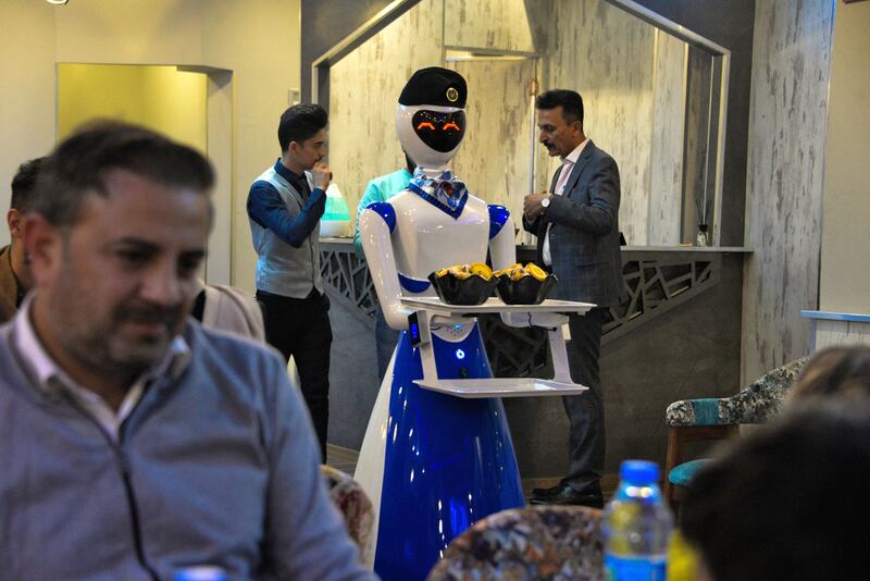 A robot waiter carries an order.