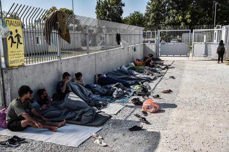 Yazidis from Iraq wait for entry to a refugee camp in Serres, northern Greece. AFP