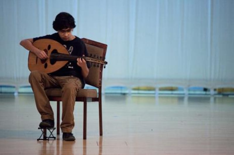 Muhammad Saadah, a 13-year-old oud player, practises his piece for Wednesday’s Speak Abu Dhabi. Lee Hoagland / The National