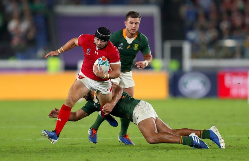 Wales' Leigh Halfpenny (left) is tackled by South Africa's Damian de Allende during the 2019 Rugby World Cup Semi Final match at International Stadium Yokohama. PA Photo