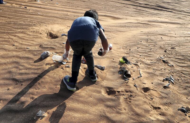 SHARJAH, UNITED ARAB EMIRATES , January 16– 2021 :- Members of the off roaders club collecting trash during the desert clean up drive at the Al Badayer desert area in Sharjah. (Pawan Singh / The National) For News/Stock/Online/Instagram/Standalone/Big Picture. Story by Nick Webster