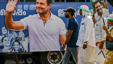 Supporters of India's Congress party walk past a cutout of their leader Rahul Gandhi, in Wayanad, Kerala. AFP