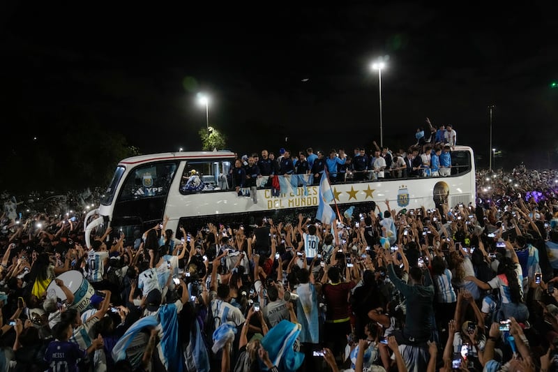 Fans welcome home the Argentine football team that defeated France on Sunday to win the World Cup. AP