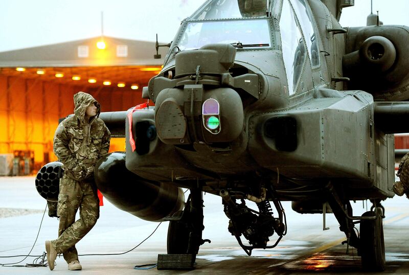 Britain's Prince Harry performs pre-flight checks of his Apache helicopter at Camp Bastion, southern Afghanistan in this photograph taken December 12, 2012, and released January 22, 2013. The Prince, who is serving as a pilot/gunner with 662 Squadron Army Air Corps, is on a posting to Afghanistan that runs from September 2012 to January 2013.  Photograph taken December 12, 2012. Photograph pixelated at source.  REUTERS/John Stillwell/Pool (AFGHANISTAN - Tags: MILITARY CONFLICT ROYALS ENTERTAINMENT POLITICS SOCIETY) *** Local Caption ***  LON706_BRITAIN-HARR_0122_11.JPG
