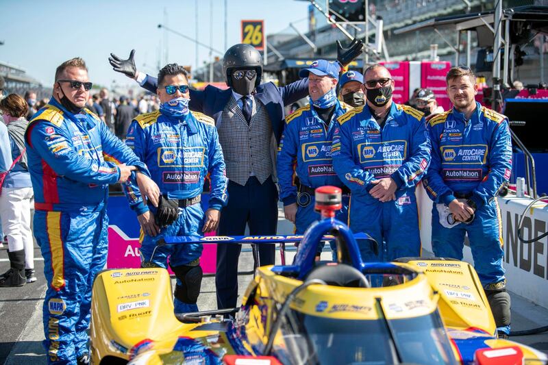 A fan known as the Suited Racer poses with crew members of Andretti Autosport driver Alexander Rossi before the 105th running of the Indianapolis 500. USA TODAY Sports