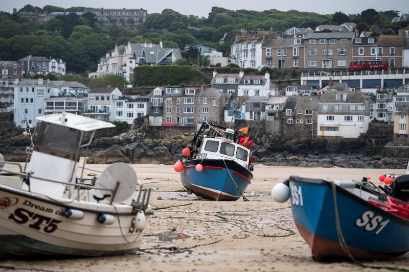 Fishing boats sit moored on the sea bed at low tide in the harbor in St. Ives, U.K. on Tuesday, May 23, 2017. The region of Southwest England matters to the Liberal Democrats, a party fighting for political relevance, as it seeks to regain a foothold in its former stronghold. Photographer: Chris J. Ratcliffe/Bloomberg