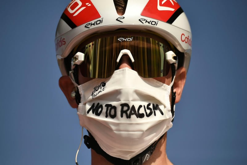 Italy's Elia Viviani wears a face mask reading "No To Racism" as he arrives for the start of the twenty-first and last stage of the Tour de France cycling race. AP Photo
