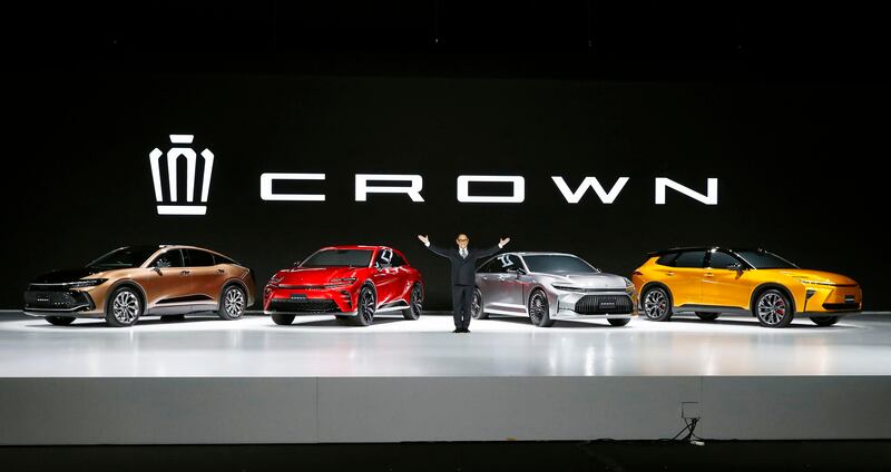 Toyota chief executive Akio Toyoda with vehicles in the latest Crown line-up near Tokyo on Friday. AP