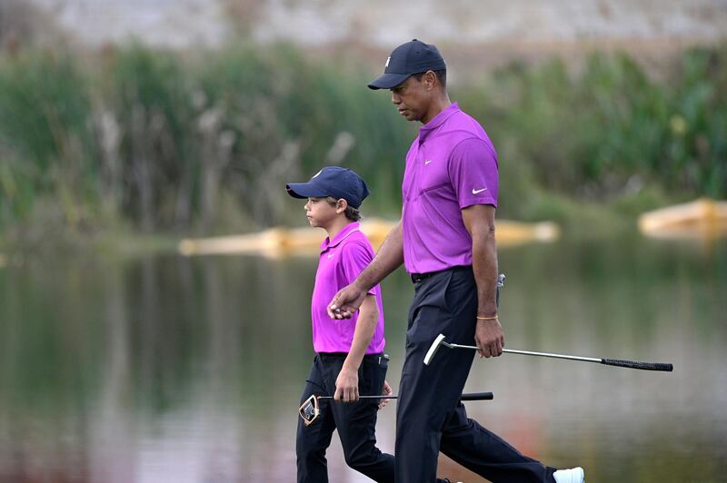 Tiger Woods and Charlie walk together to the 16th green. AP