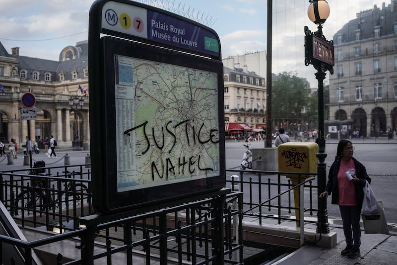 Graffiti reading "Justice Nahel" scrawled on the Palais Royal Musee du Louvre Metro sign in Paris. Getty Images