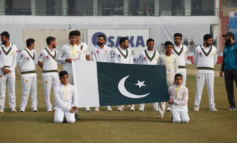 Pakistan players stand for the national anthems before start of play on the first day of the first Test against Sri Lanka in Rawalpindi. AP