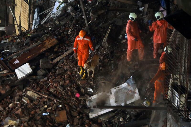 National Disaster Response Force  personnel look for survivors trapped in the rubble. REUTERS/Francis Mascarenhas