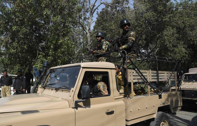 Pakistani troops patrol near the Chinese consulate in Karachi.  AFP