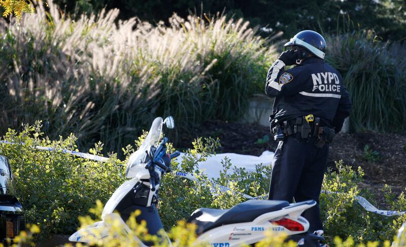 A NYPD officer stands guard at a crime scene near a bike path where a body is covered with a white-sheet in lower Manhattan in New York, NY, U.S., October 31, 2017. REUTERS/Brendan McDermid